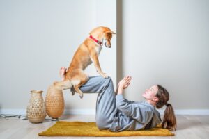 Healthy dog doing yoga with owner. Benefits of CBD for dogs.